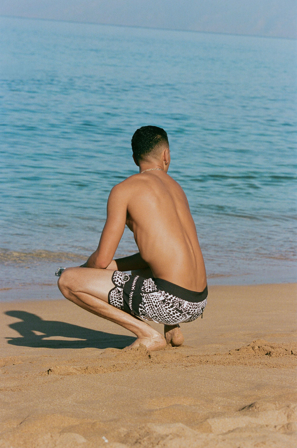 Leopard cone shell board shorts